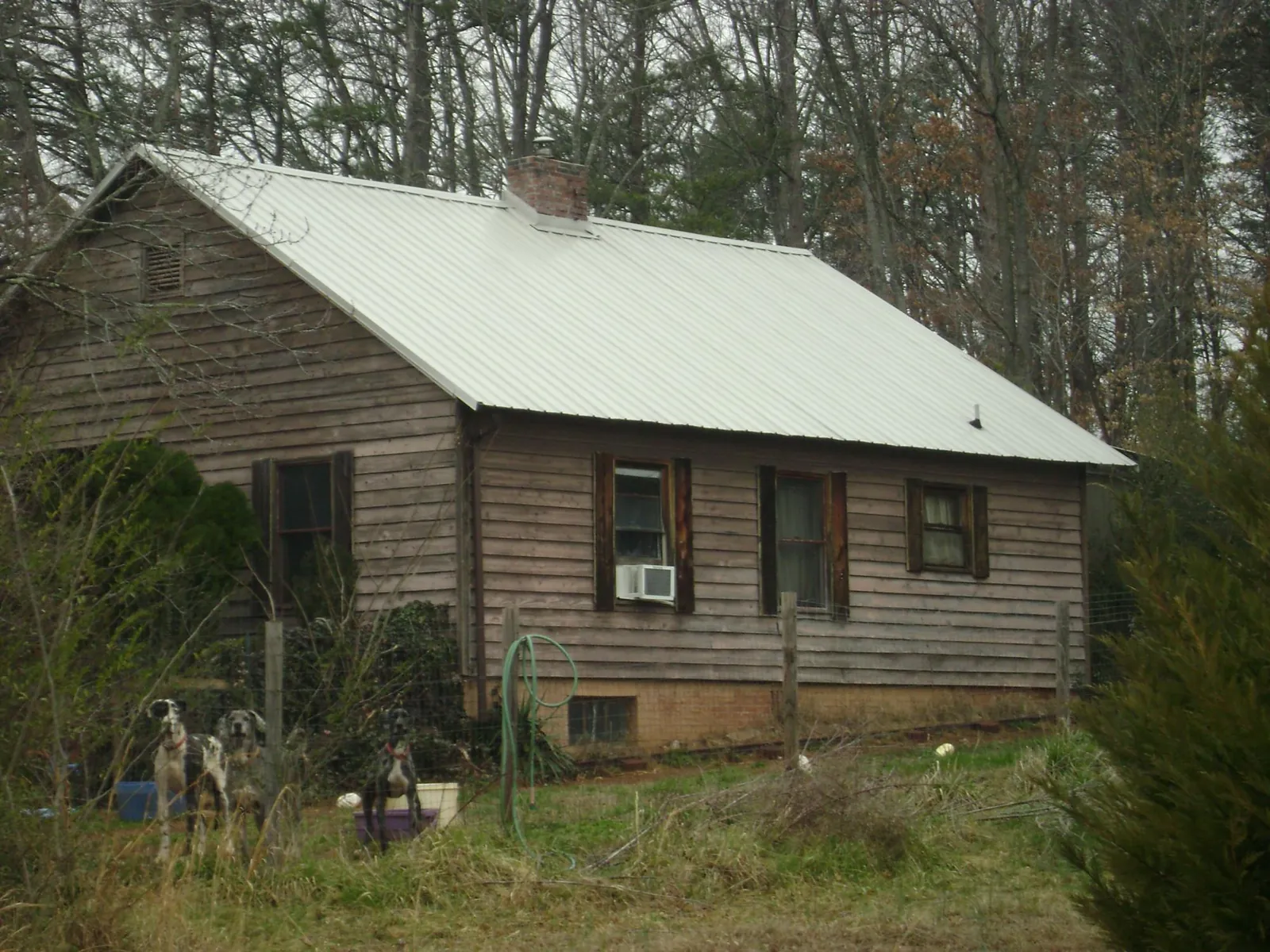 White metal roof on an old wood sided farmhouse, from a Metal Roof Installation job in Salineville